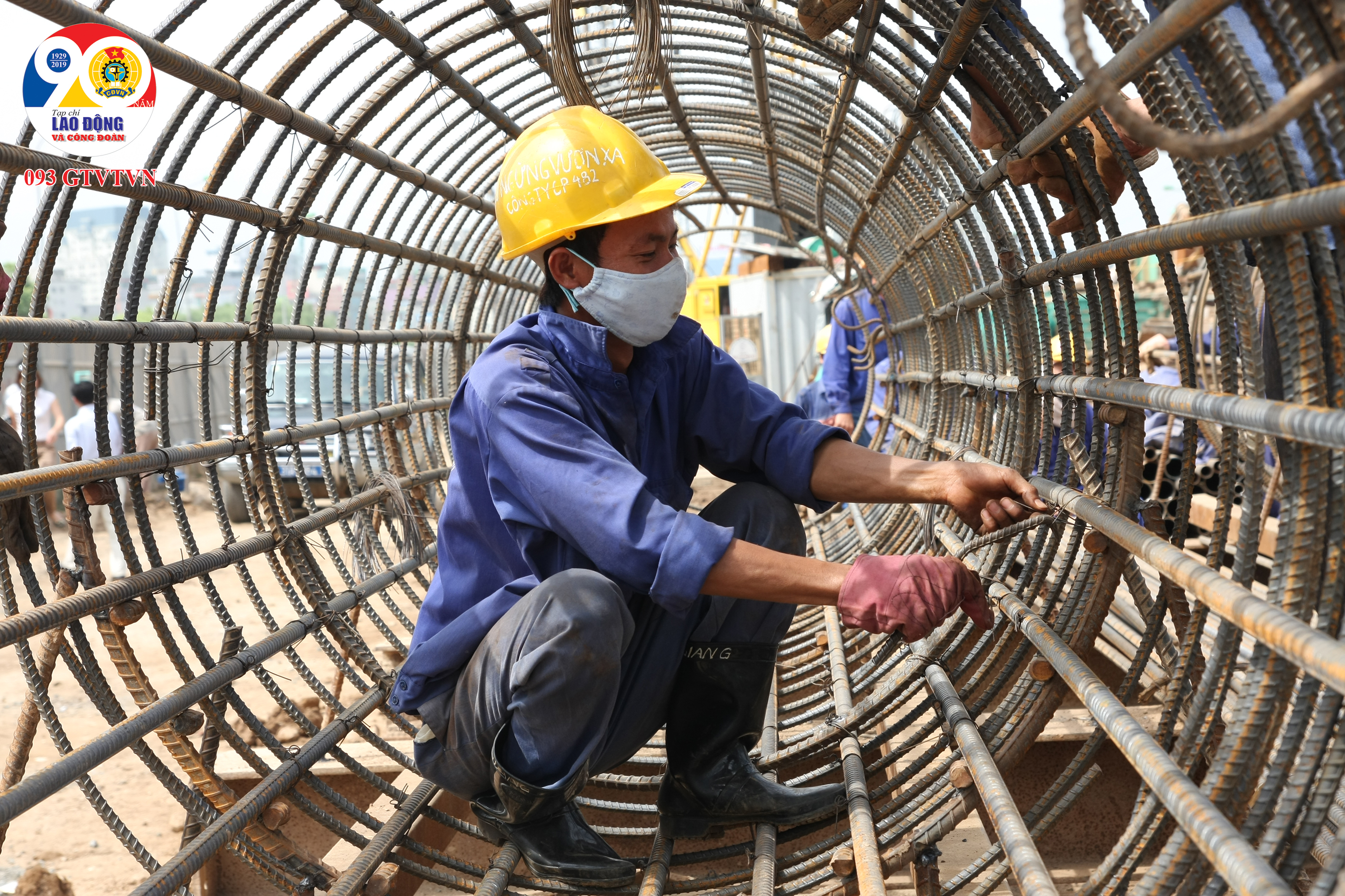 Công nhân luồn dây thép để móc lồng thép trước khi đổ bê tông